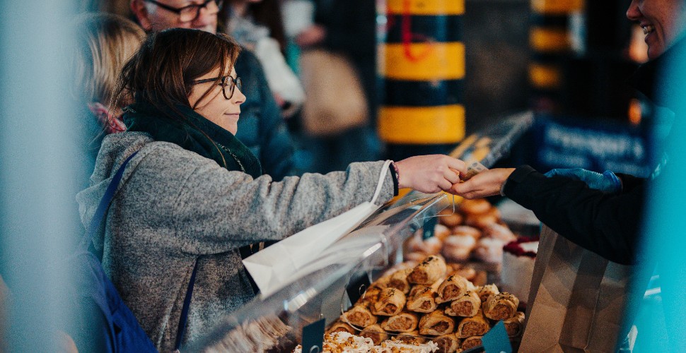 Woman paying for goods at Royal William Yard market